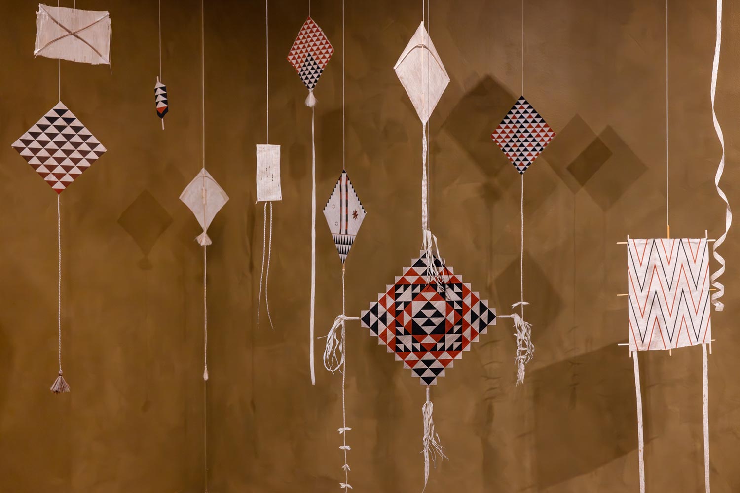 Image credit: Nikau Hindin, <i>Kites</i>, 2022, Installation view, Ten thousand suns, 24th Biennale of Sydney 2024, UNSW Galleries. Photo: Jacquie Manning. Courtesy the artist